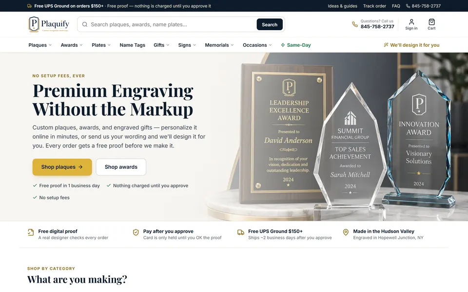 The Plaquify home page: "Premium Engraving Without the Markup," with an engraved walnut plaque and two crystal awards.